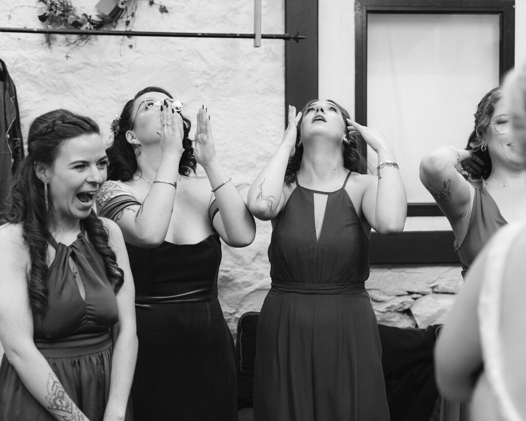 Bridesmaids cry and smile as they look at their bride. Top tips for wedding photographs.