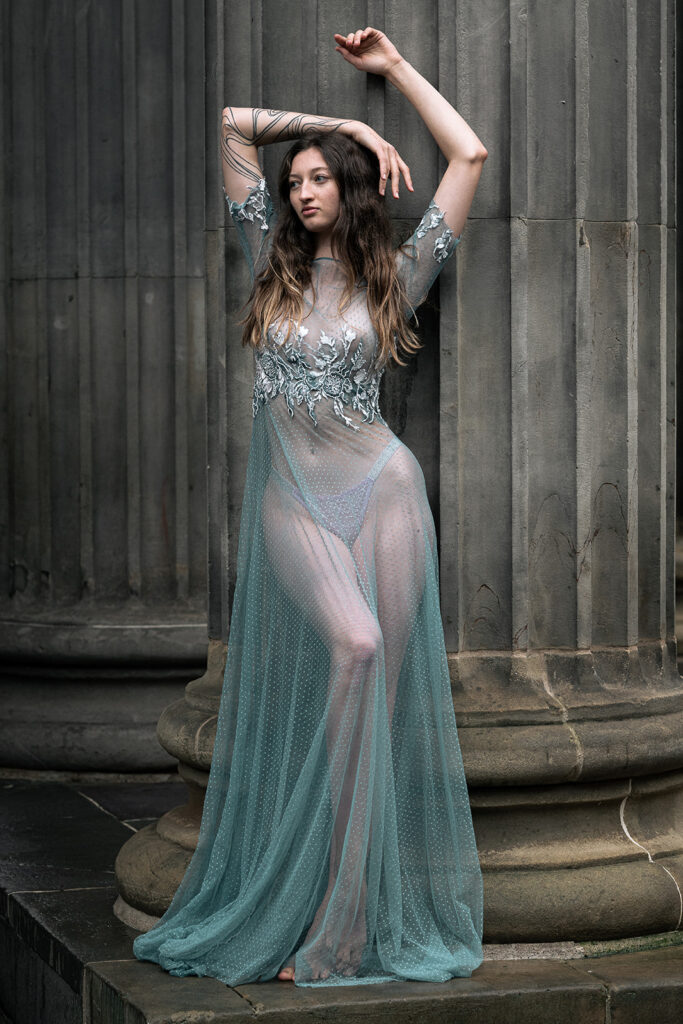 A bride poses in a bespoke weddings dress. The style of photography is editorial.