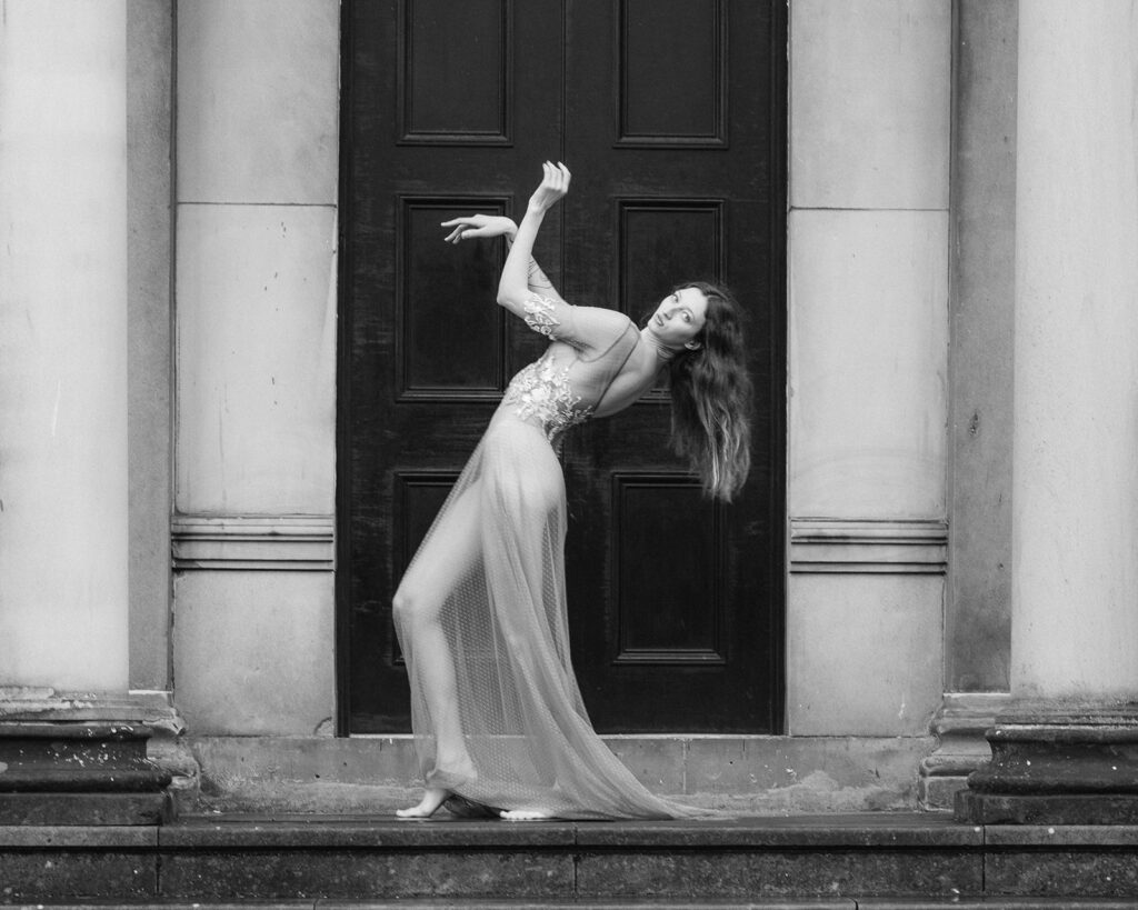 A bride poses in a bespoke weddings dress. The style of photography is editorial. Editorial Wedding Photographer.