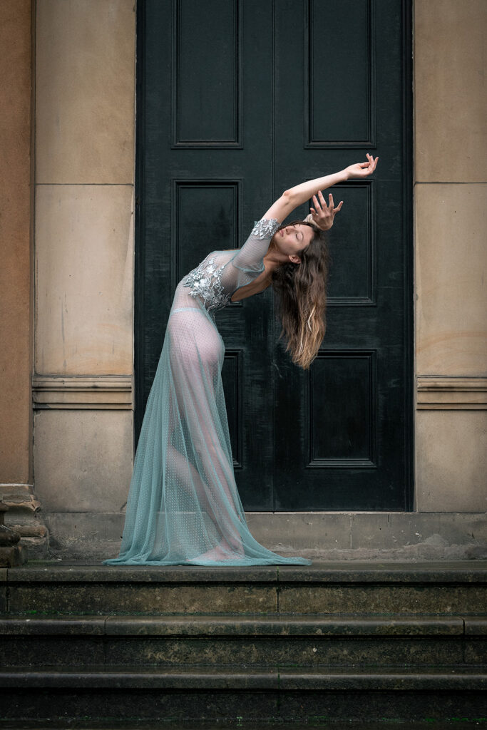 A bride poses in a bespoke weddings dress. The style of photography is editorial.