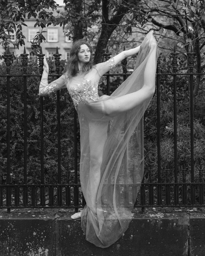A bride poses in a bespoke weddings dress. The style of photography is editorial. Editorial Wedding Photographer