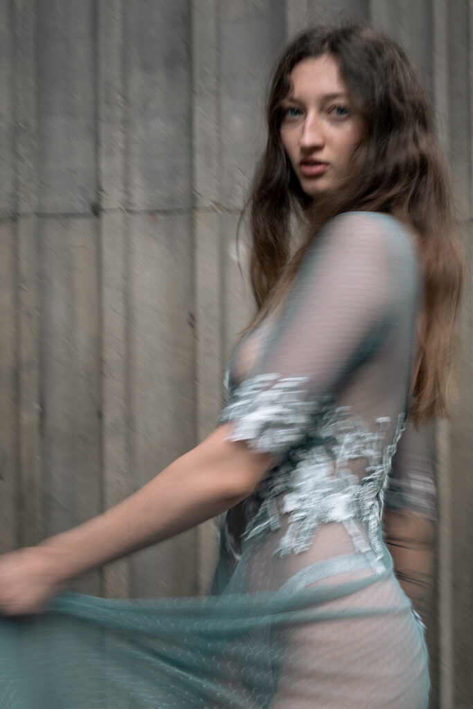 A bride poses in a bespoke weddings dress. The style of photography is editorial.